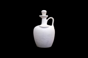 white plaster jug isolated on a black background