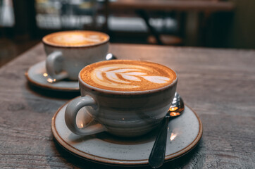 Cup of cappuccino with decorative figure in milk
