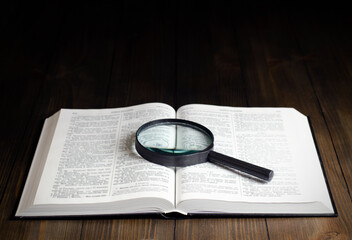 Open Bible. On the table. Holy Bible, Scripture. Magnifier	