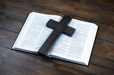Bible open. Cross, crucifixion of Jesus. Love concept. On a wooden table.