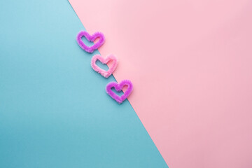Fluffy hearts on a blue and pink background. St. Valentine's Day. Concept of love and spring. Top view, background, copy space 