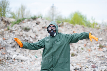 A man in a protective mask and protective clothing explores the danger zone. Ecological...