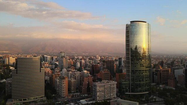 Aerial dolly in of Titanium La Portada&nbsp;skyscraper and neighborhood buildings on a cloudy day, Santiago, Chile