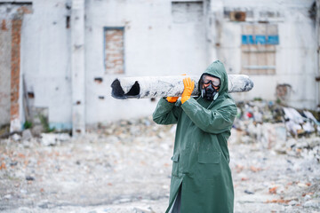 A man in a protective mask and protective clothing explores the danger zone. Ecological...