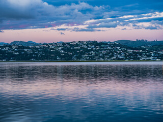 Knysna lagoon and town during a twilight sky and reflection on water in South Africa