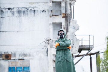 A man in a protective mask and protective clothing explores a dangerous radioactive area.