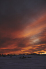 Evening clouds above Lensbygda, Toten, Norway, at sunset in winter.