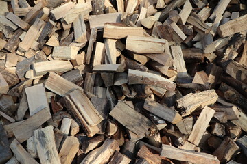 a huge pile of roughly chopped firewood near the hut
