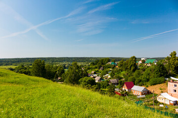 View from a high hill to the rustic buildings below. Outskirts of the city of Maloyaroslavets, view from the settlement to the area