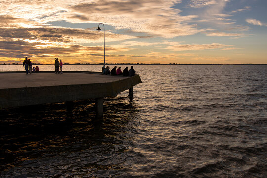Chascom&uacute;s main dock with expressive sky at sunset, in Chascom&uacute;s lagoon, Buenos Aires, Argentina with some clouds
