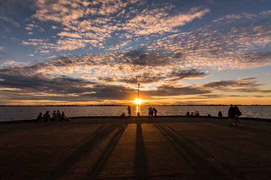 Chascom&uacute;s main dock with expressive sky at sunset, in Chascom&uacute;s lagoon, Buenos Aires, Argentina with some clouds
