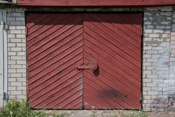 Old wooden garage door in a brick building.