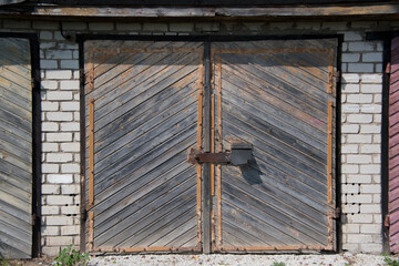 Old wooden garage door in a brick building.