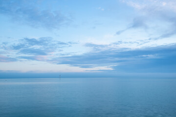 Obraz premium Cloudy blue minimalist seascape. Deserted space with horizon line.