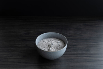 Isolated grey bowl of ashes for ash wednesday on a dark wood background with copy space shot from...