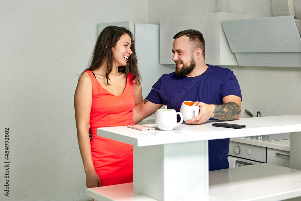 Wall mural flirt in office kitchen between colleagues during break.