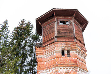 Old red brick and wooden water tower by the railway, Kandava, Latvia.