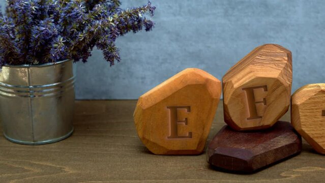 Letters EFT written on wooden blocks. Emotion-focused therapy treatment concept. Camera slide.