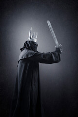 Warrior with horned helmet and sword in the dark 