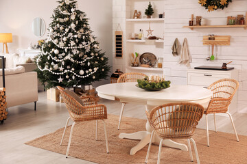 Cozy dining room interior with Christmas tree and festive decor