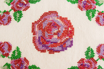 Decorative element, cross-stitch embroidery of rose flowers. - obrazy, fototapety, plakaty