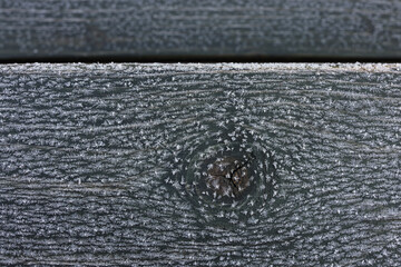 Frozen pattern and snowflakes on wooden planks knot pattern. Color photo for background. 
