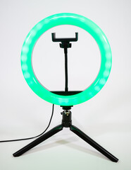Ring lamp on a small tripod. Green light.