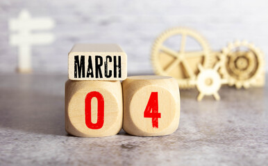 Vintage photo, March 4th. Date of 4 March on wooden cube calendar, copy space for text on board.