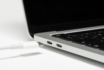 Close up shot of usb c cable plugging to a laptop computer