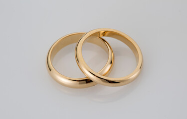 Diamond gold wedding rings on background