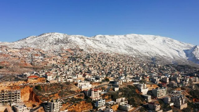 Hermon mountain ridge covered with snow during 2022 winter, with the town houses of Majd al Shams.
