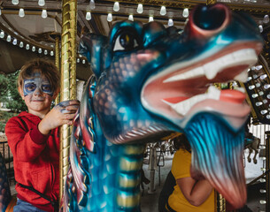 Boy on carousel with face paint