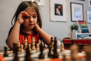 Smart child playing Chess girl