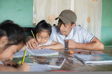 Hispanic father helping his daughters do their homework - teacher teaching girls to read and write...