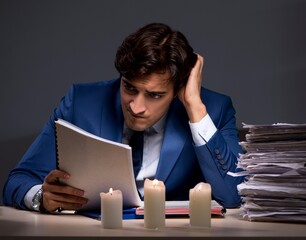 The businessman working late in office with candle light