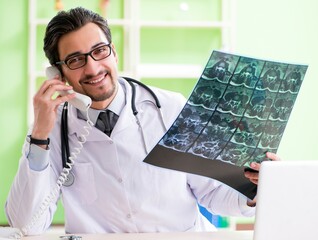 Doctor radiologist looking at x-ray scan in hospital