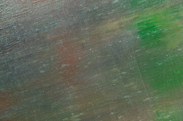 abstract colored creative background - rough linen canvas unevenly covered with multi-colored primers, reflections of light. Toning, blurring, selective focus. Temporary object.