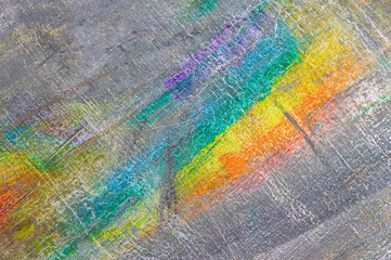abstract rainbow multicolored background formed by erasing paints from the canvas, short focus. Not an art object, temporary effect.