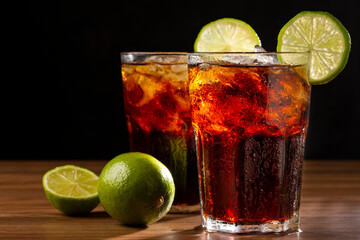 Coke glasses with ice cubes and lemon.