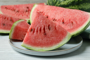 Slices of tasty ripe watermelon on white wooden table, closeup