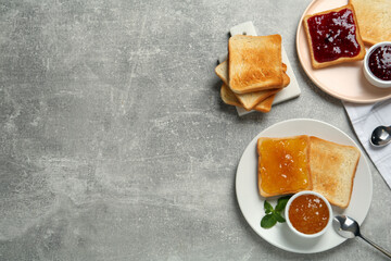 Delicious toasts with jams served on light grey table, flat lay. Space for text