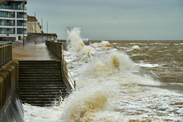 Crashing waves hit the sea wall