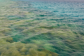 Waves on the surface of the turquoise tropical sea.
