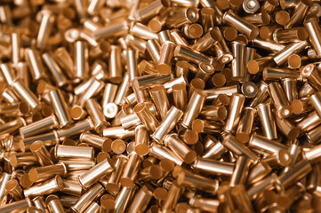 Pile of golden shells of bullets as background close view