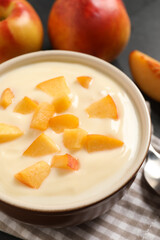 Delicious yogurt with fresh peach on table, closeup