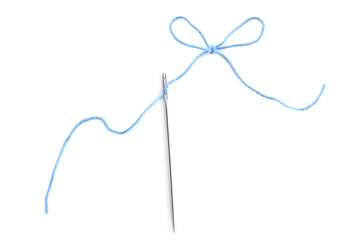 Needle with light blue sewing thread on white background, top view