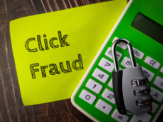 Top view padlock and calculator with text Click Fraud on wooden background.