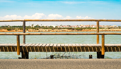 Skyline framed by a wooden bridge, in the Salinas de San Pedro del Pinatar, Murcia, Spain.