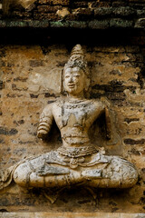 Beautiful ancient stucco carving life size deities on wall of historic Wat Chet Yot or Wat Jed Yod buddhist temple, famous landmark of Chiang Mai, Thailand