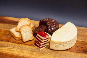 Sweet, romeo and juliet, Cheese with guava on wooden board and black background